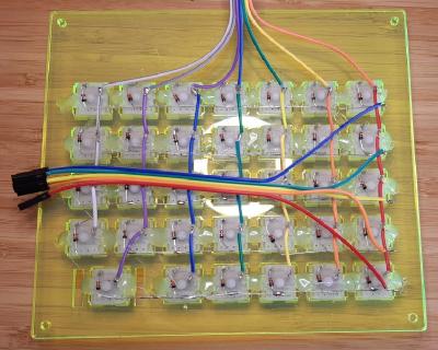 The underside of the custom mechanical keyboard, showing the rows connected with diodes and columns connected with wire.
